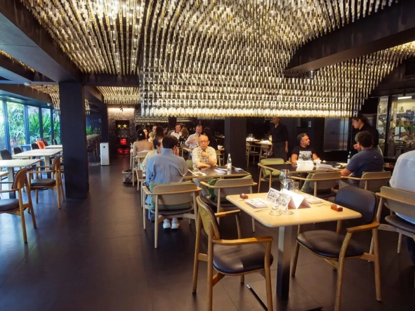 Interior of Le Du restaurant in Bangkok, featuring a stylish ceiling design and dining patrons.