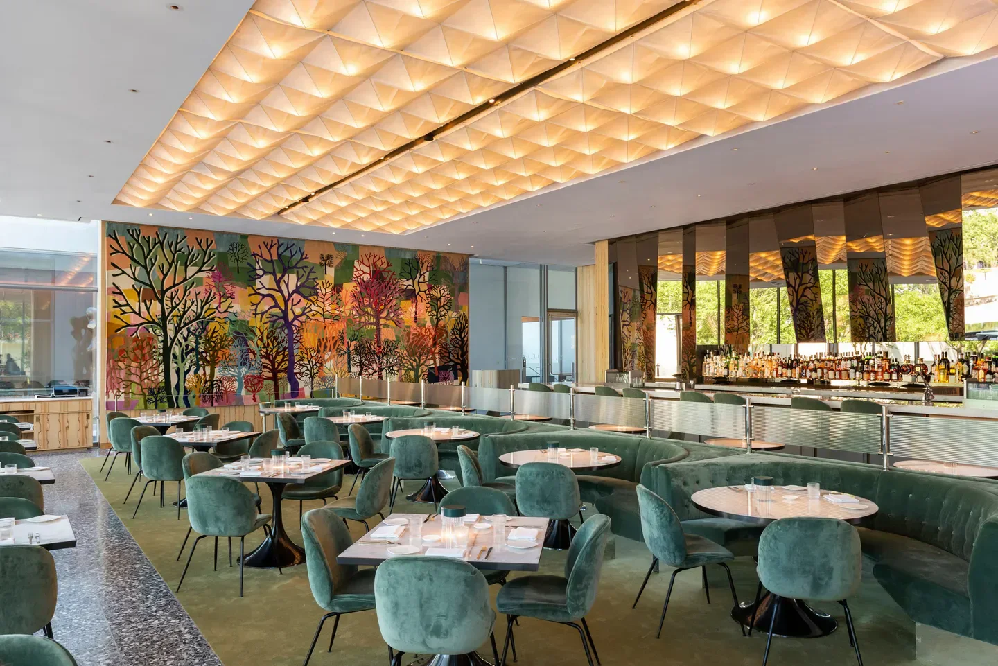 Stylish interior of Le Jardinier Houston restaurant with colorful wall art in Houston.