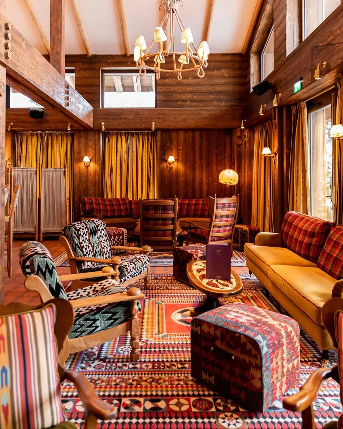 Cozy interior of Le Piaf restaurant in Megeve, with wooden walls and vintage decor.