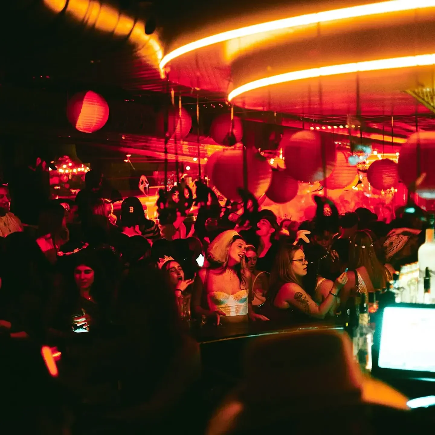 Energetic nightlife scene at Le Rouge Bar in Montreal, with crowds and red ambiance.