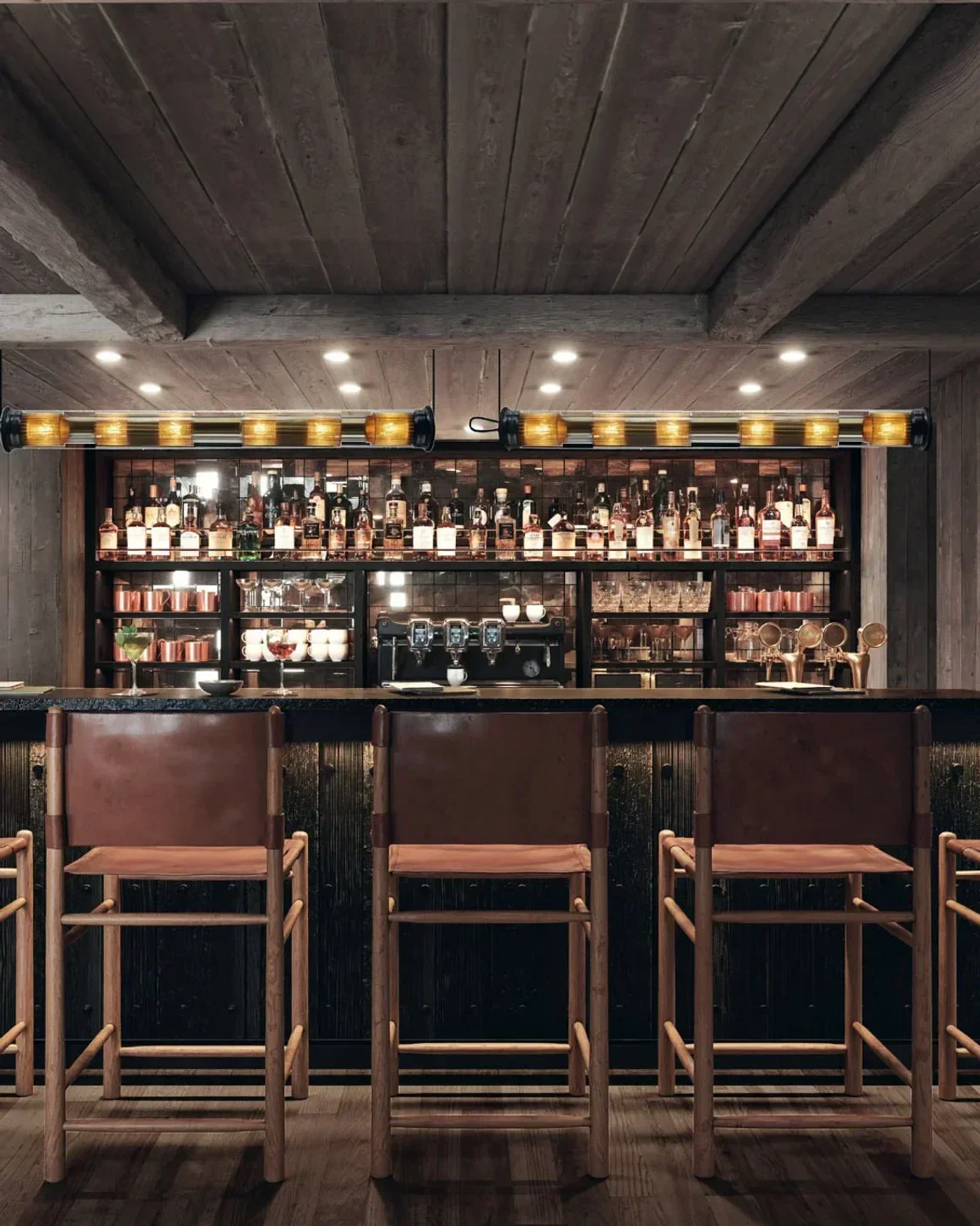 Interior bar at Le Savoy in Meribel, featuring wooden beams and leather chairs.