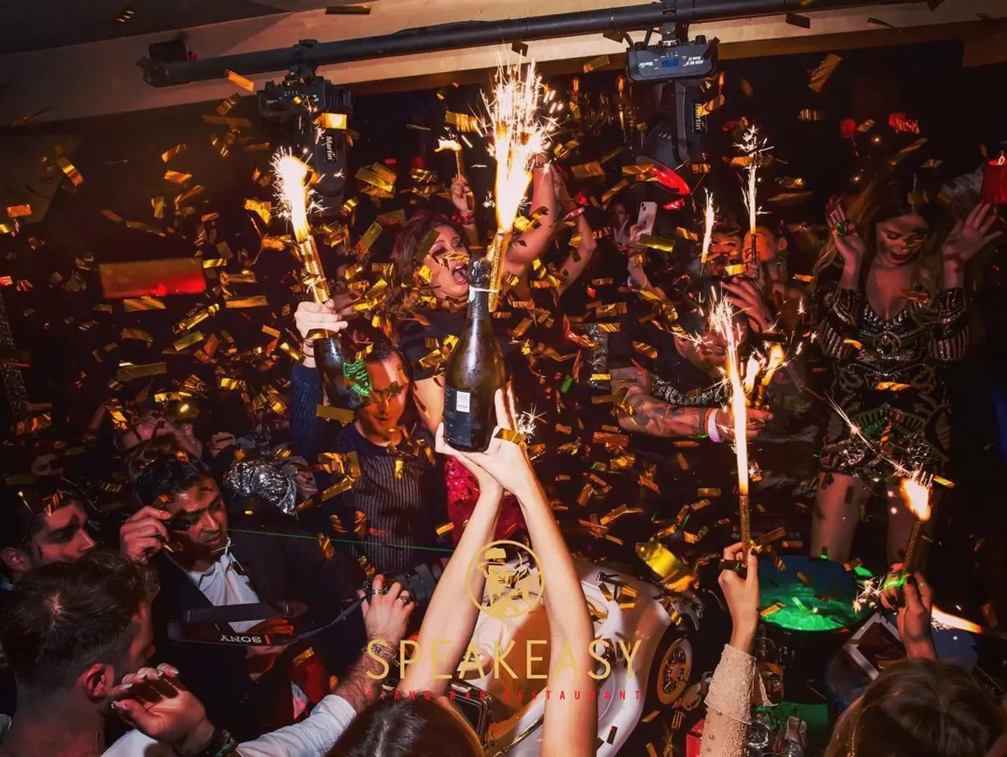 Celebratory atmosphere at Le Speakeasy nightclub in Paris, with confetti and sparklers