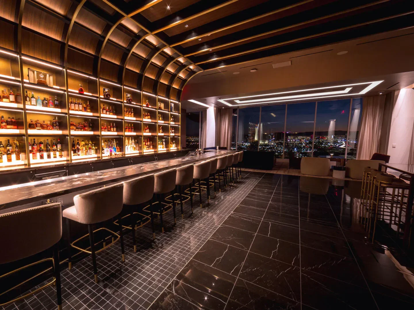 Legacy Club in Las Vegas, showcasing bar with city view at dusk.