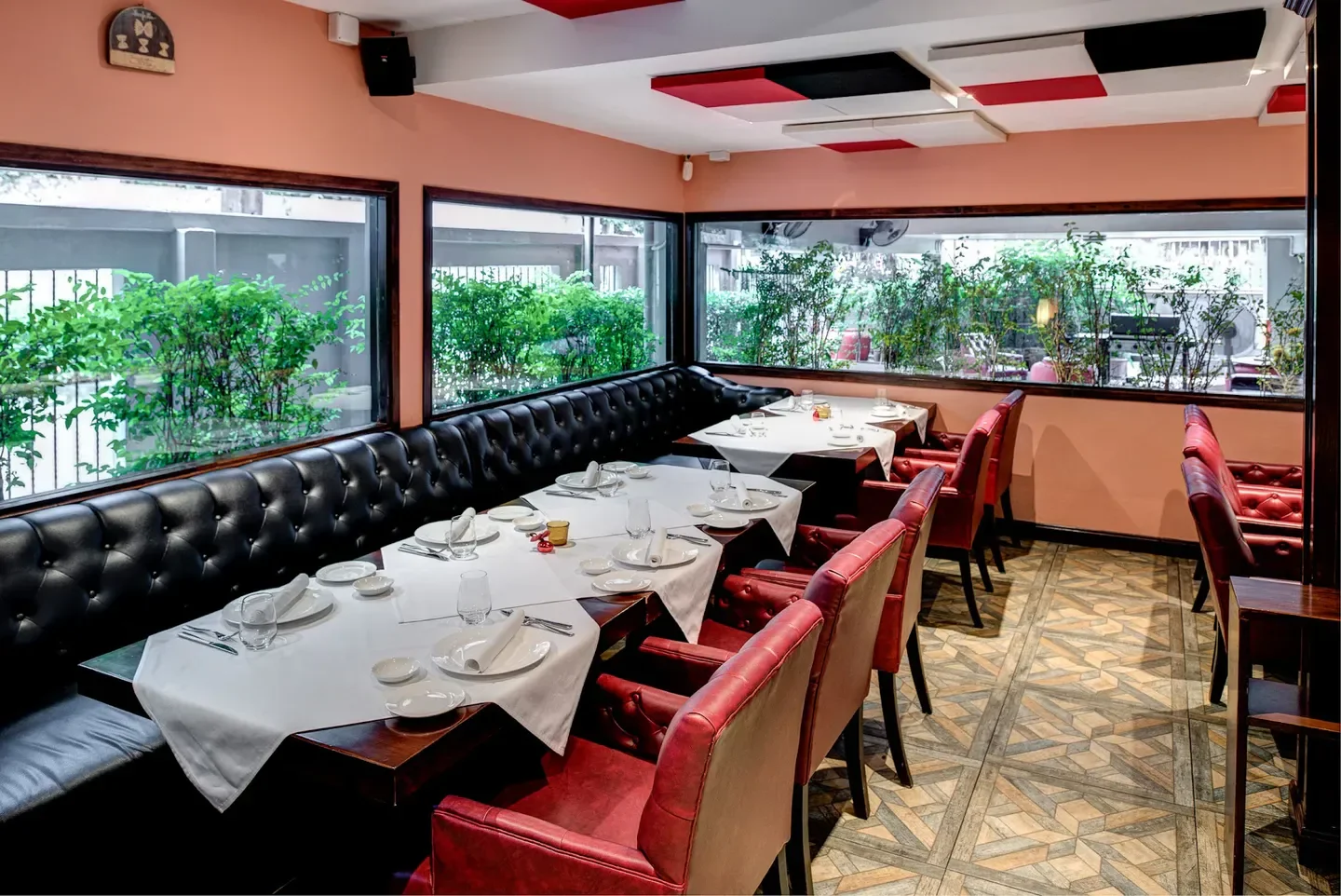 Interior dining space at Lenzi Tuscan Kitchen in Bangkok with tables set for service.