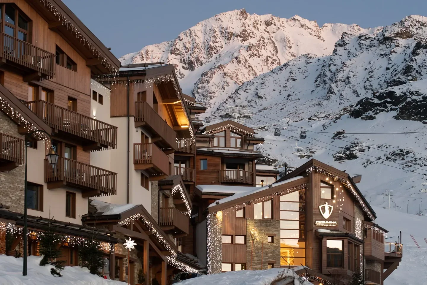 Les Explorateurs restaurant in Val Thorens with a snow-covered mountain backdrop and ski lift.