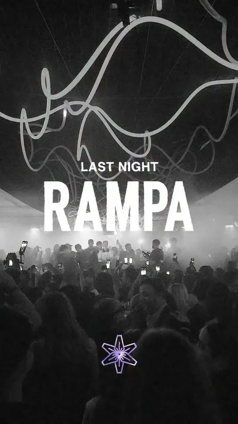Crowd with hands up at Lilly's Club in the city, illuminated by dramatic lighting and "RAMPA" text.