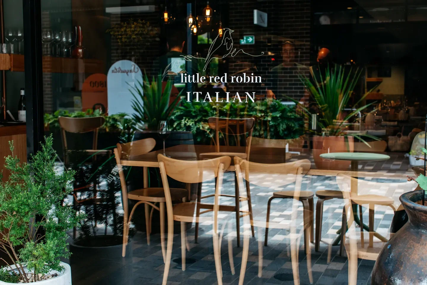 Little Red Robin Italian restaurant in Sydney with wooden chairs and inviting atmosphere