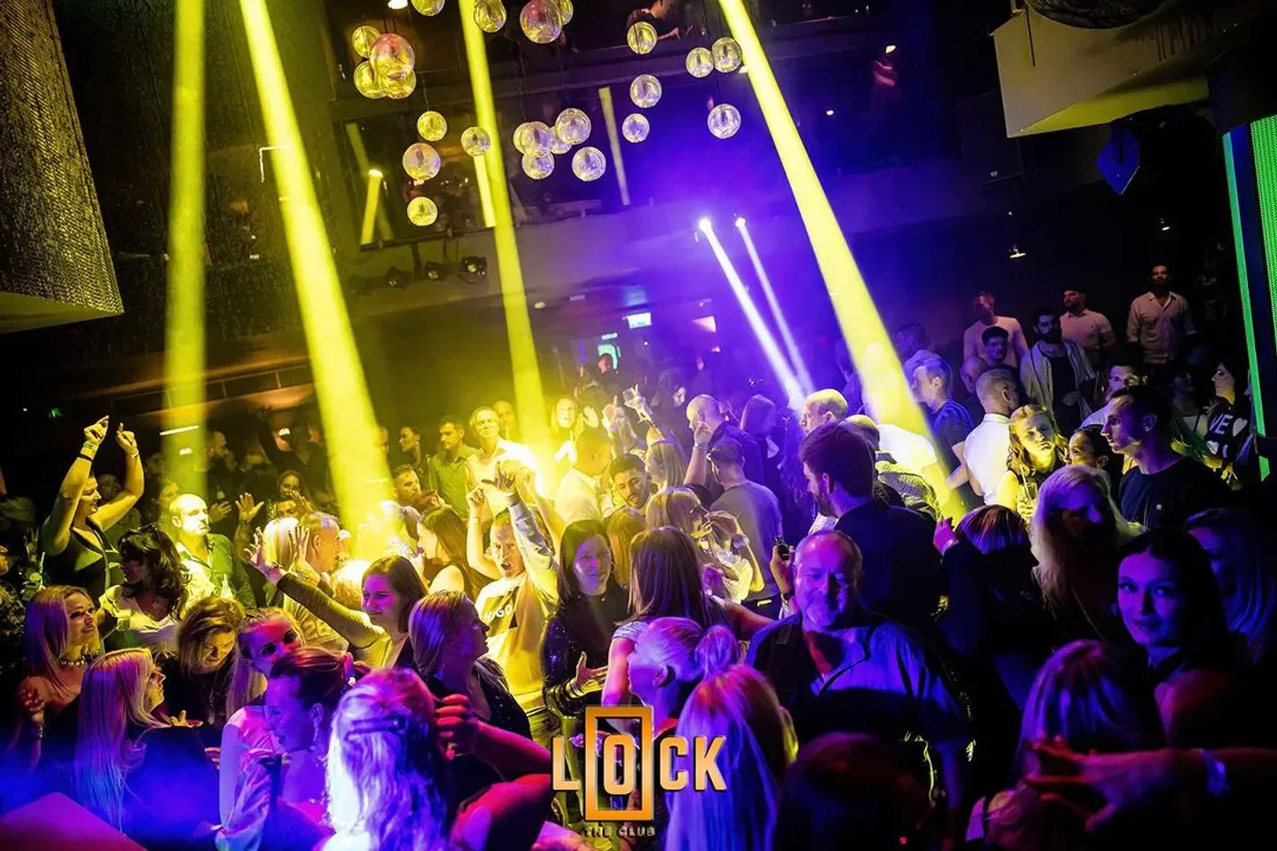Energetic crowd enjoying the night at LOCK the club in Budapest, under vibrant lights.