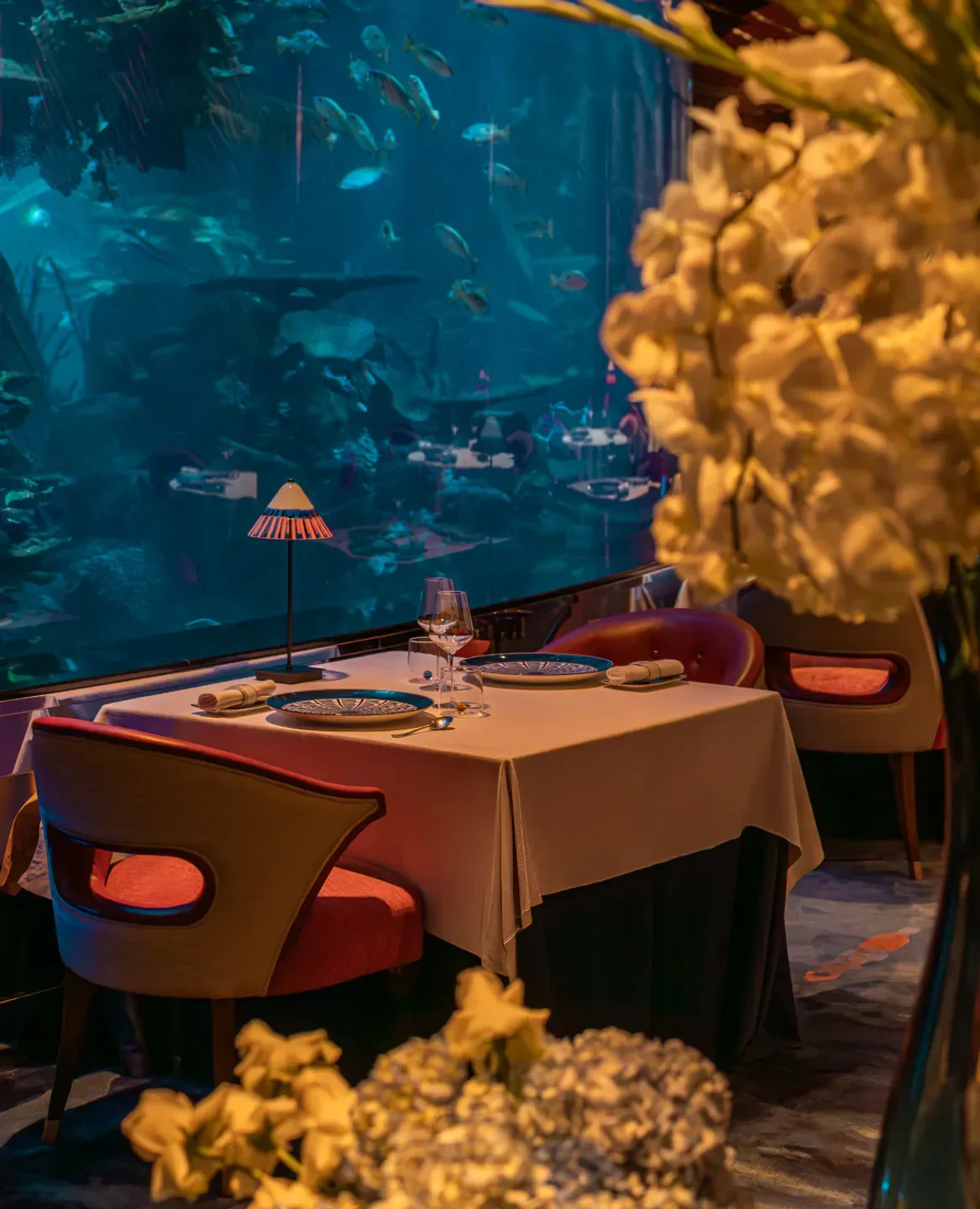 Dining at L'Olivo at Al Mahara restaurant in Dubai with aquarium views and fish.