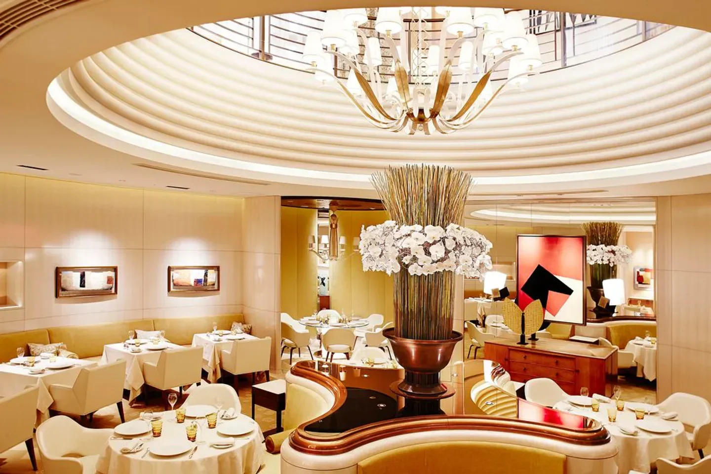 Elegant interior of L'OSIER in Tokyo, featuring a stylish chandelier and dining tables.