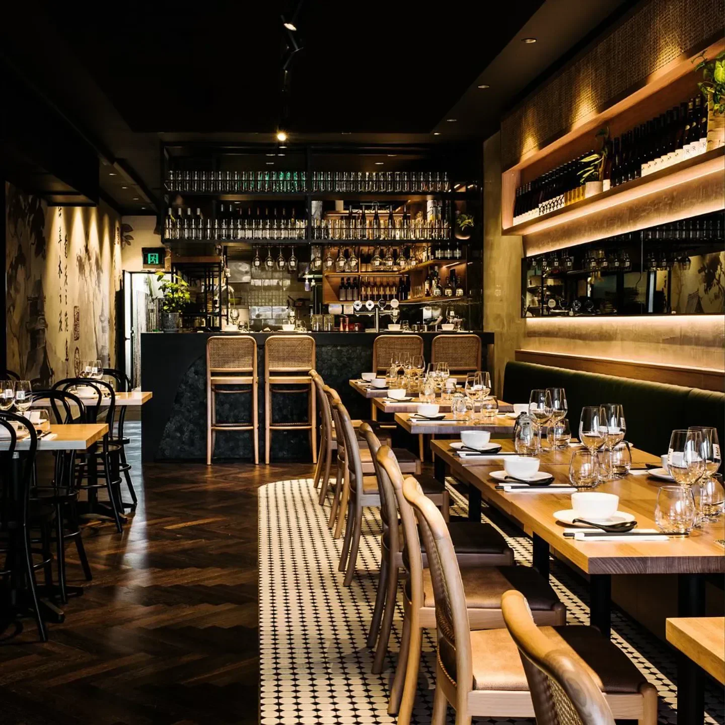 Interior of Lotus Dumpling Bar - Walsh Bay, Sydney, with tables set for dinner service.
