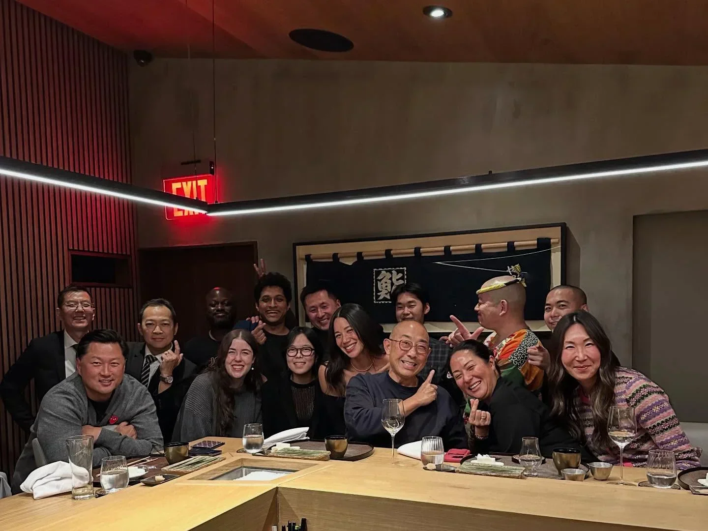 Group photo at Ltd Edition Sushi in Seattle, smiling and posing for the camera.