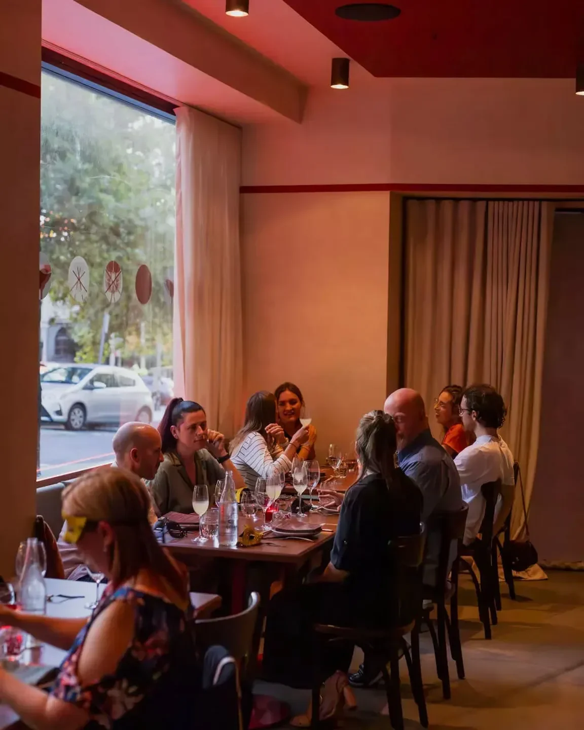 Group dining at Luc-San restaurant in Sydney, enjoying food and drinks.