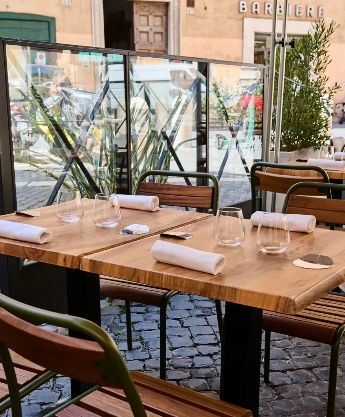 Outdoor seating at Luciano Cucina Italiana restaurant in Rome, ready for guests.