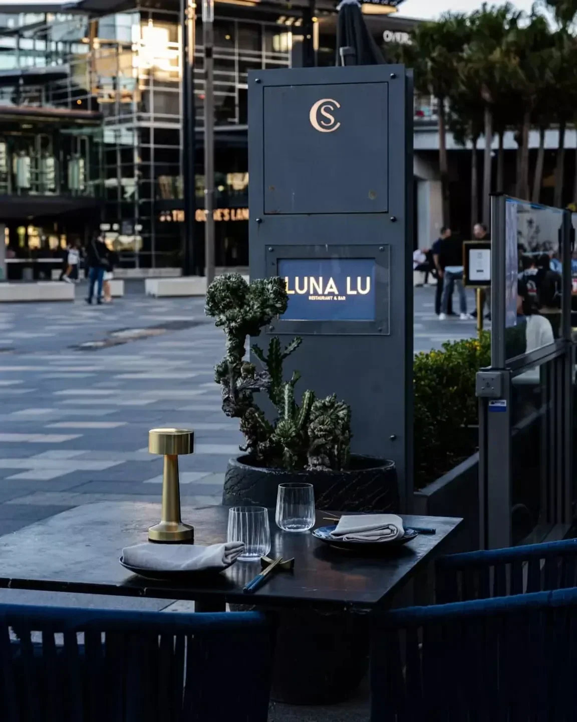 Outdoor dining at Luna Lu restaurant and bar in Sydney, featuring stylish table setting.