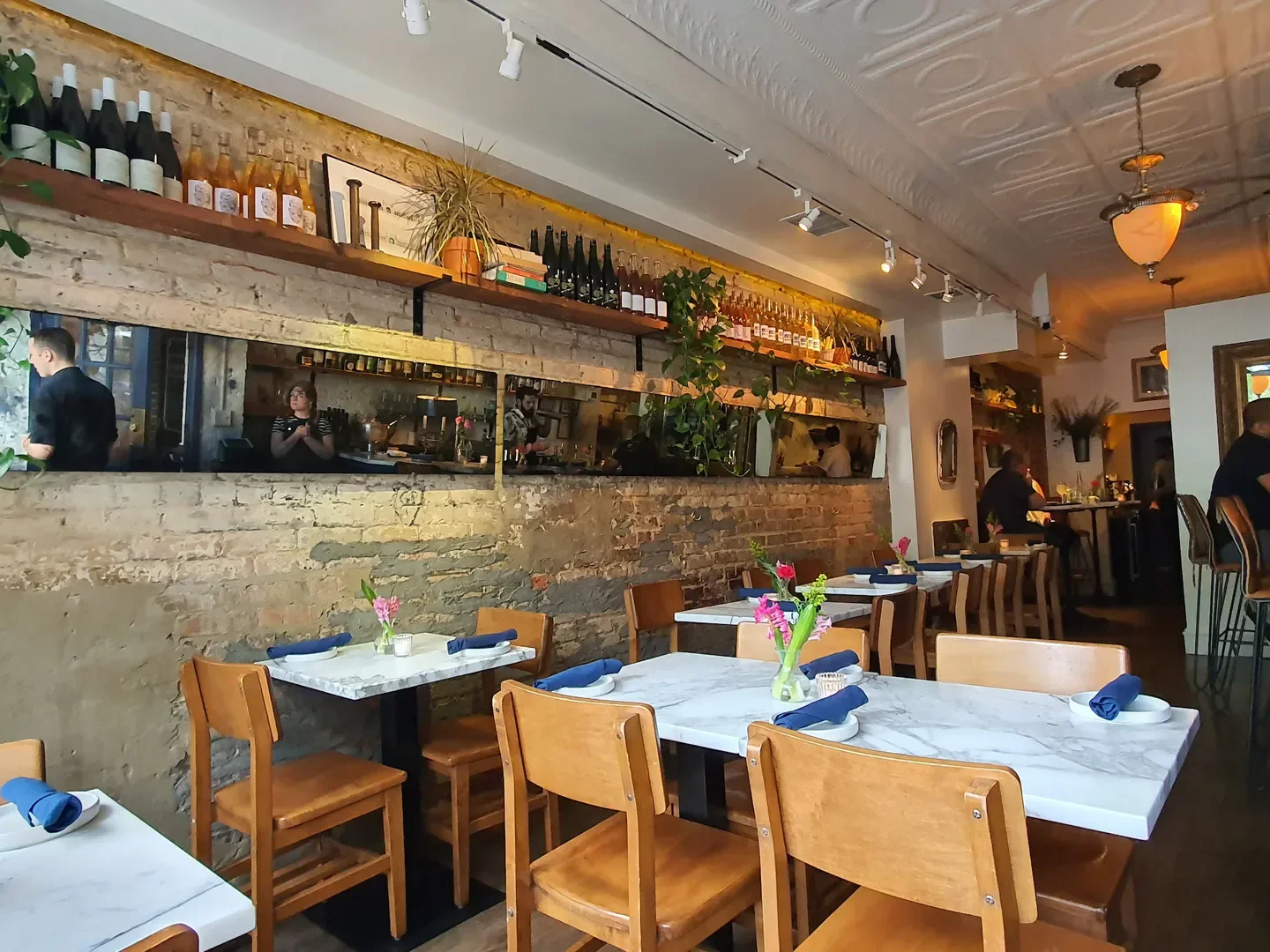 Interior of Lutèce in Washington: tables set, exposed brick, and a cozy dining room.