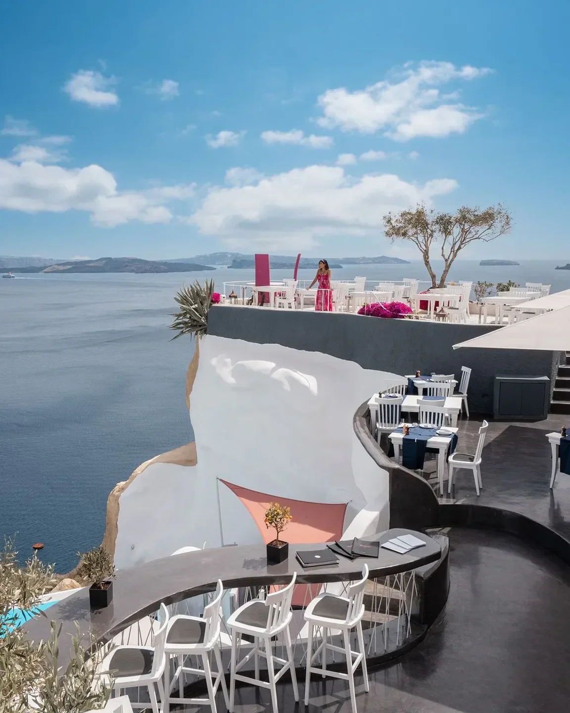 Lycabettus restaurant in Santorini with stunning sea views and white chairs and tables