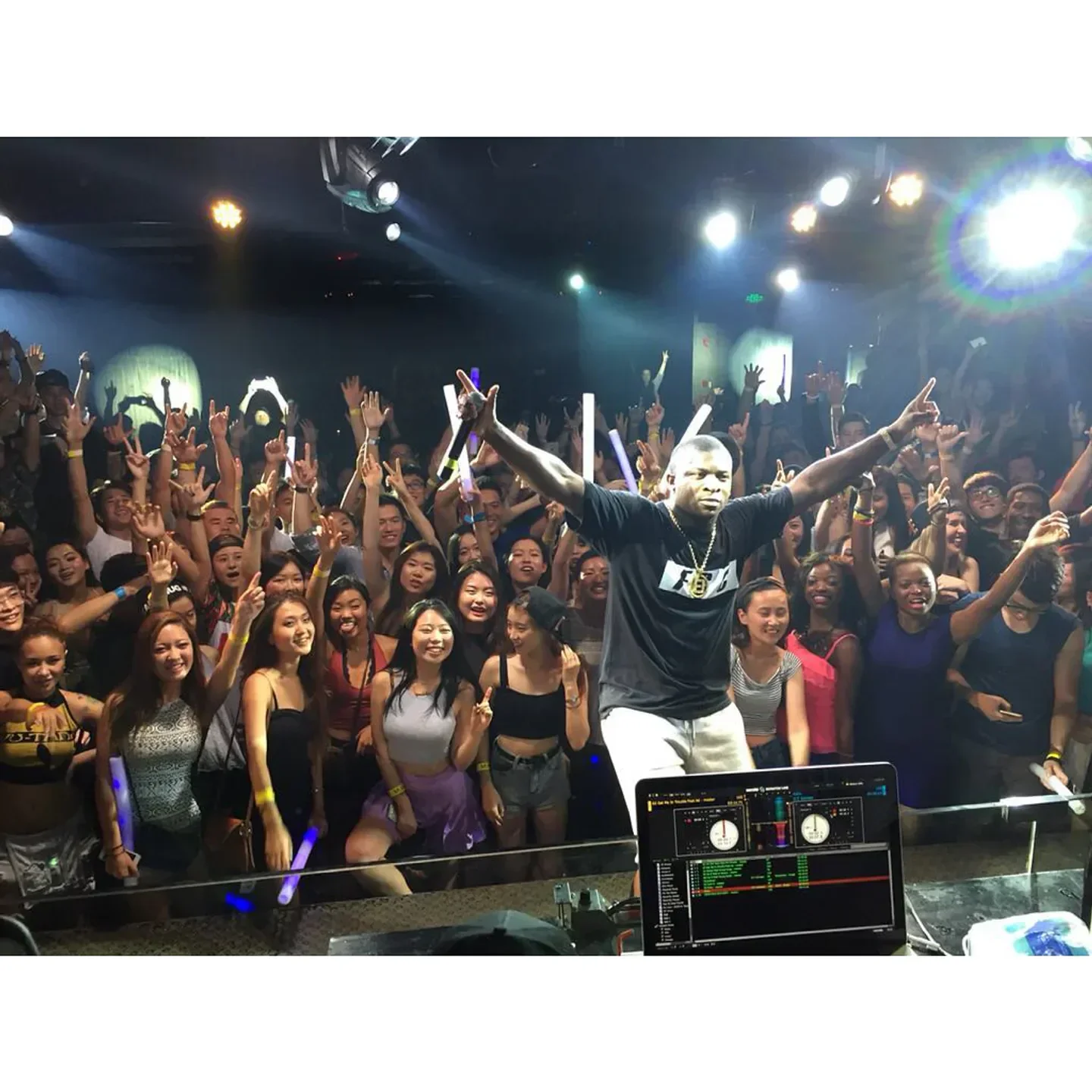 Energetic crowd at M2 nightclub in Shanghai, enjoying the live DJ performance.
