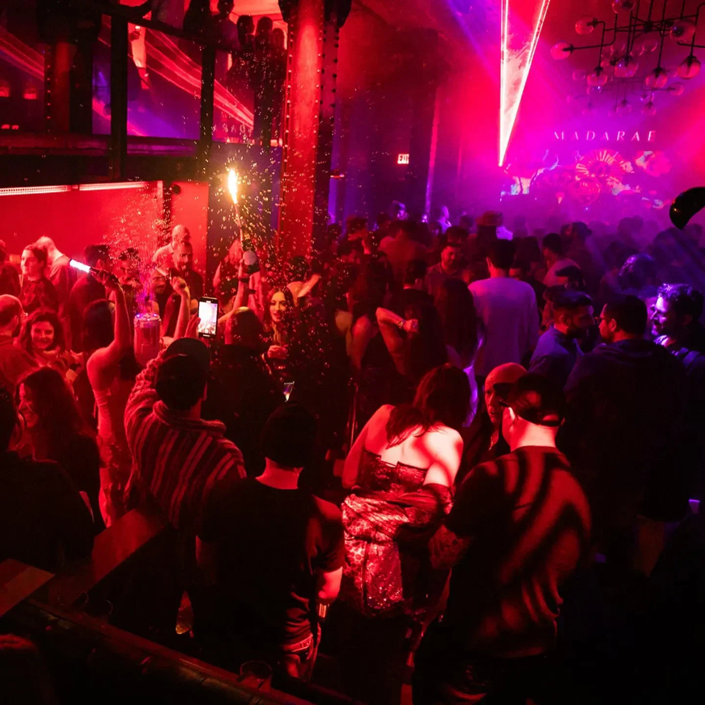 Energetic nightlife scene at Madarae nightclub in San Francisco, with crowd and festive lights