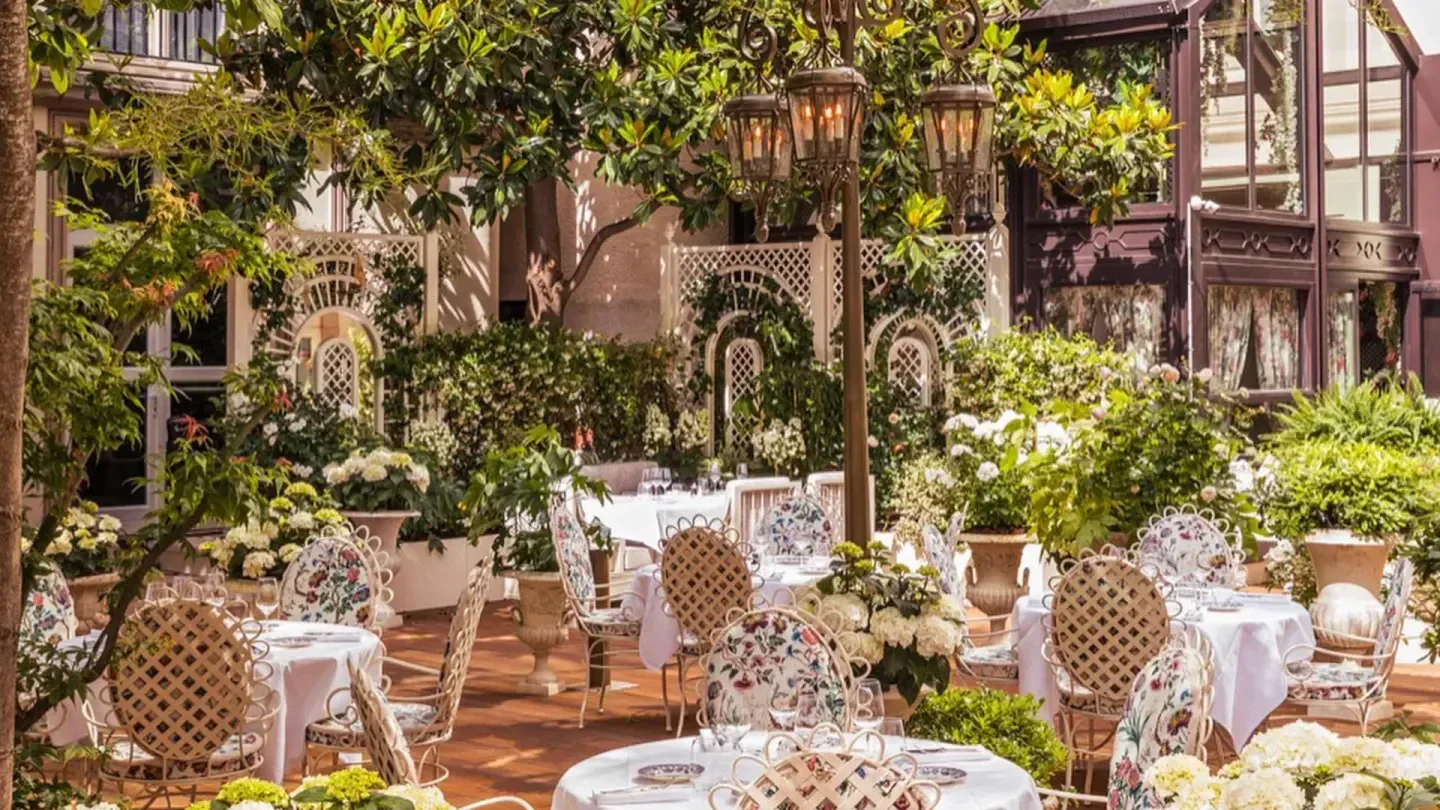 Outdoor dining at Maison Revka in Paris, with elegant tables and floral chairs