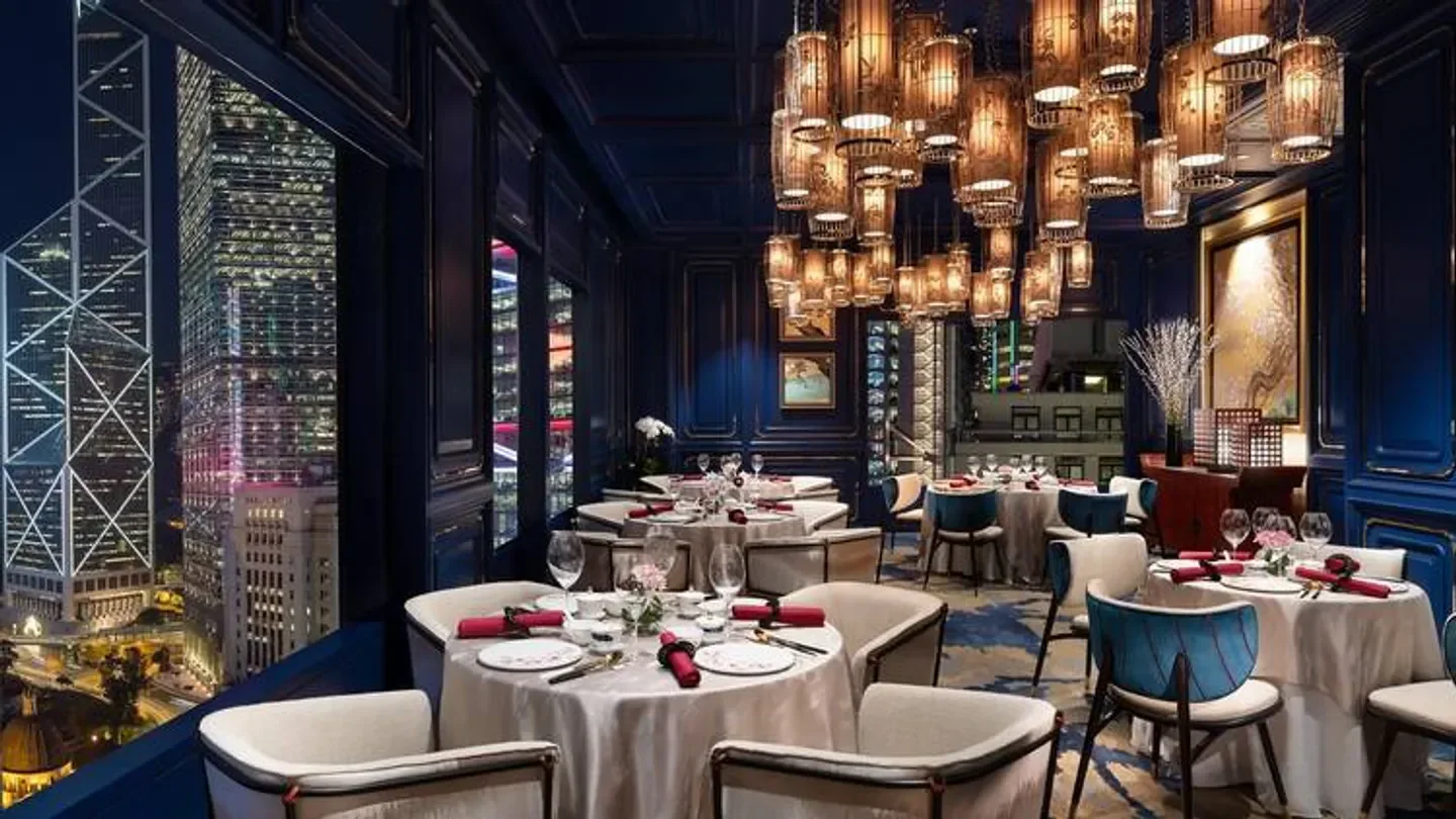 Elegant dining room at Man Wah restaurant in Hong Kong, with cityscape views and decor