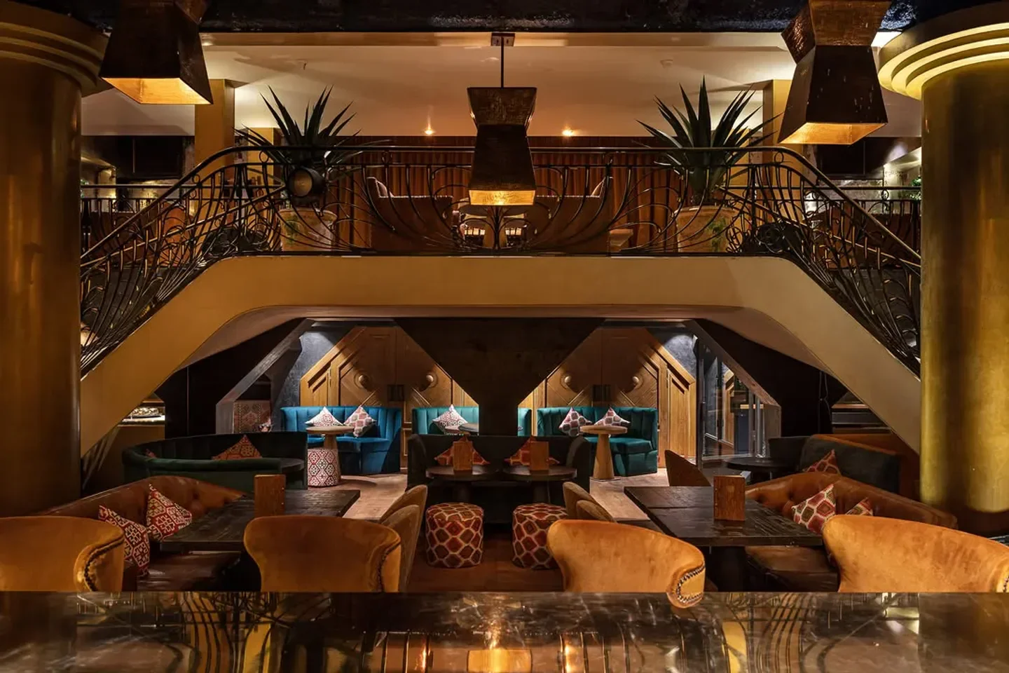 Elegant interior of Manko restaurant in Paris, featuring a grand staircase and cozy seating.