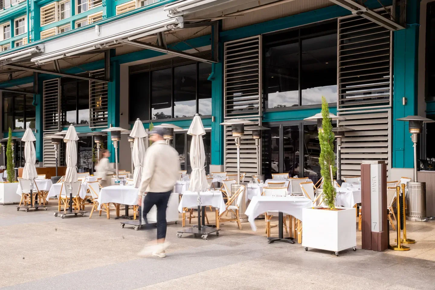Outdoor dining at Manta restaurant in Sydney, featuring tables and umbrellas
