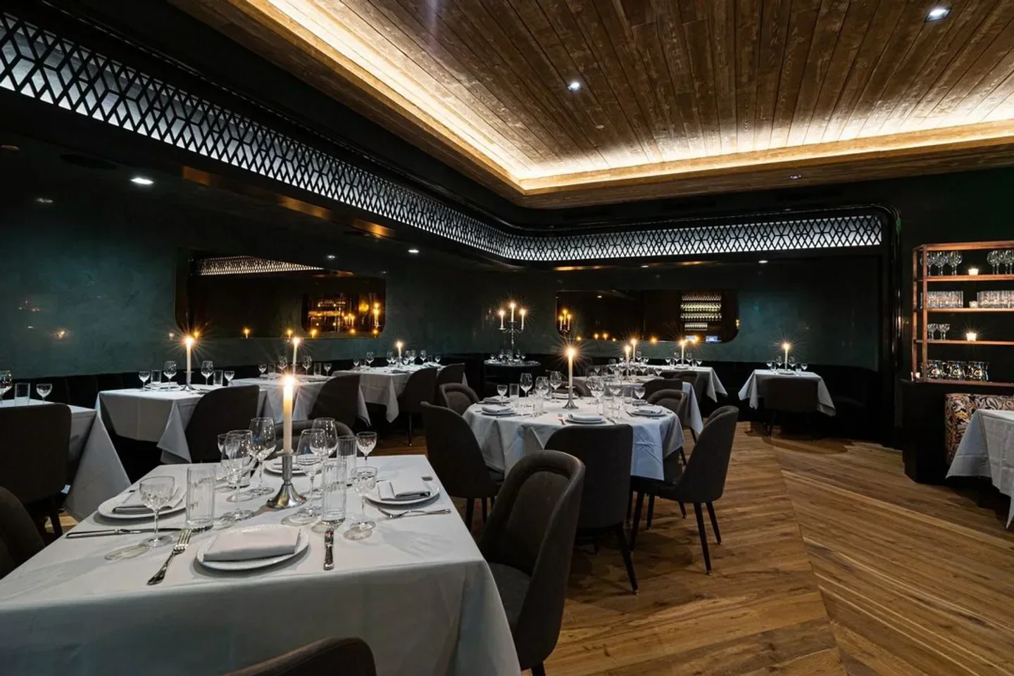 Elegant dining room interior at Maple & Ash in Scottsdale, featuring candlelit tables.