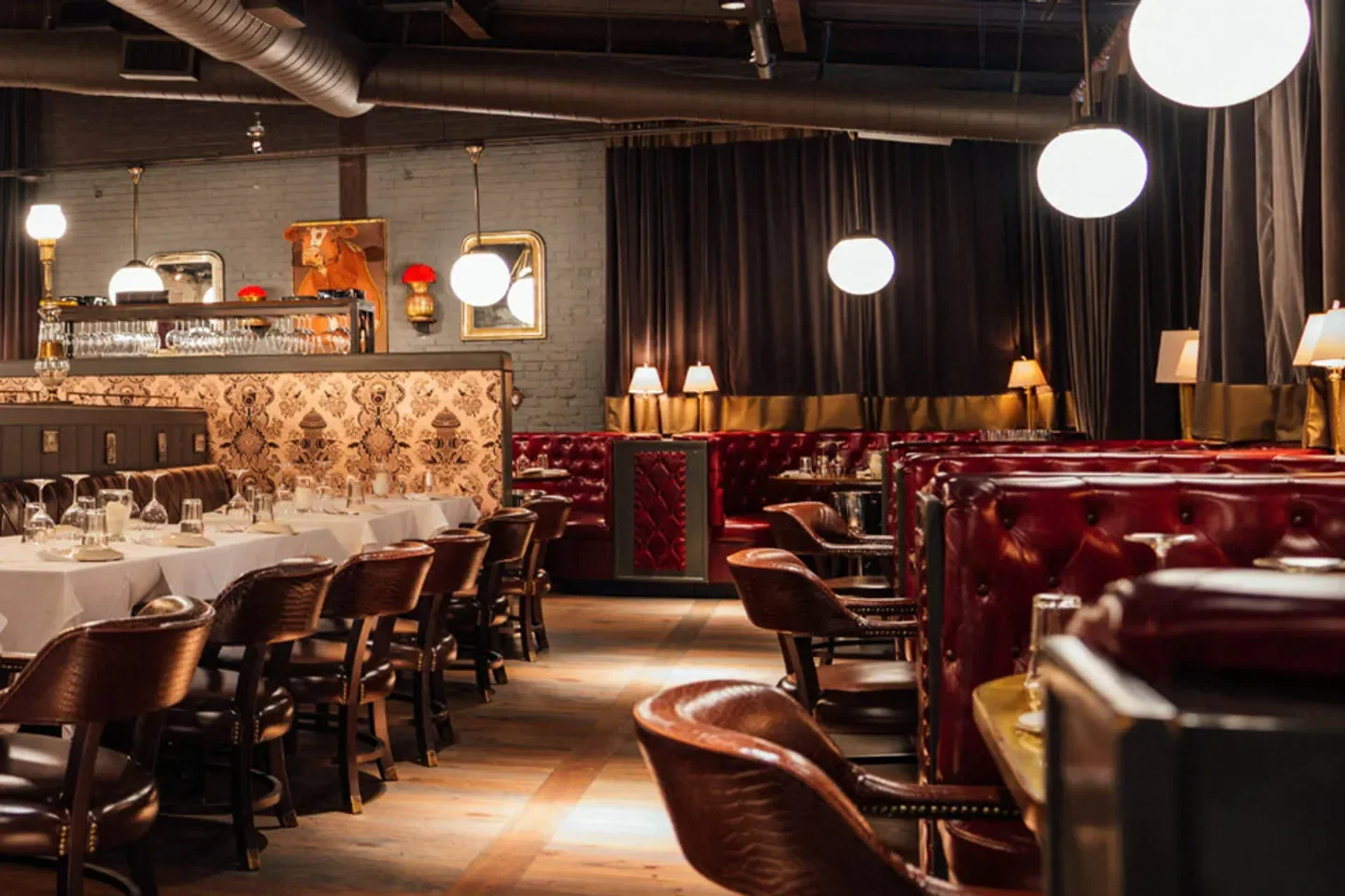 Elegant dining area at Marcel restaurant in Atlanta, featuring leather booths and decor.