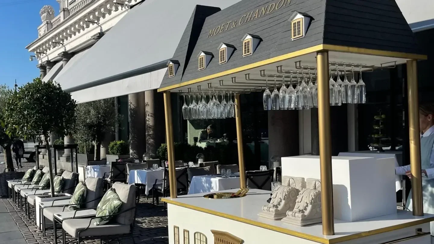 Outdoor seating at Marchal restaurant in Copenhagen, featuring a champagne bar.