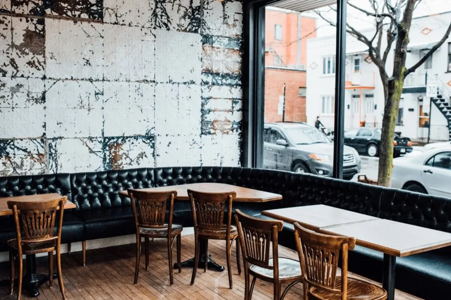 Interior of Marconi restaurant in Montreal, featuring wooden chairs and a vintage design.