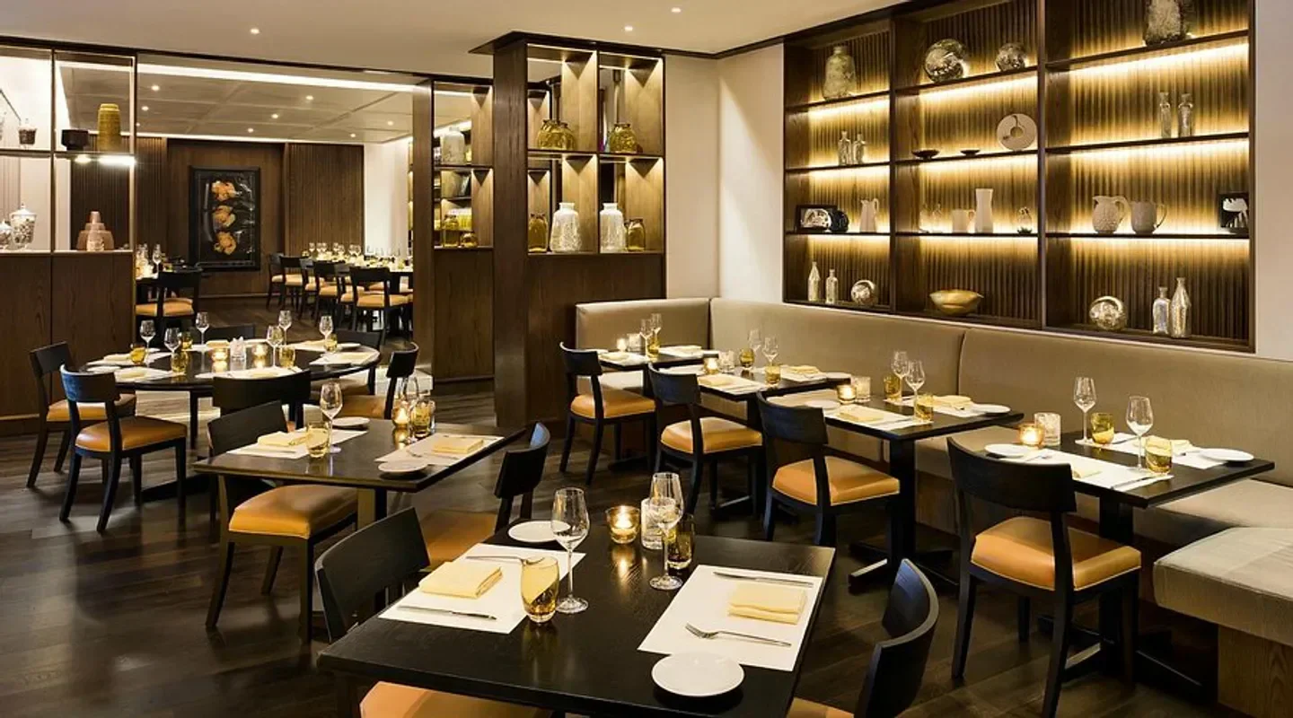Interior dining at Market by Jean-Georges in Doha, featuring elegant table settings.