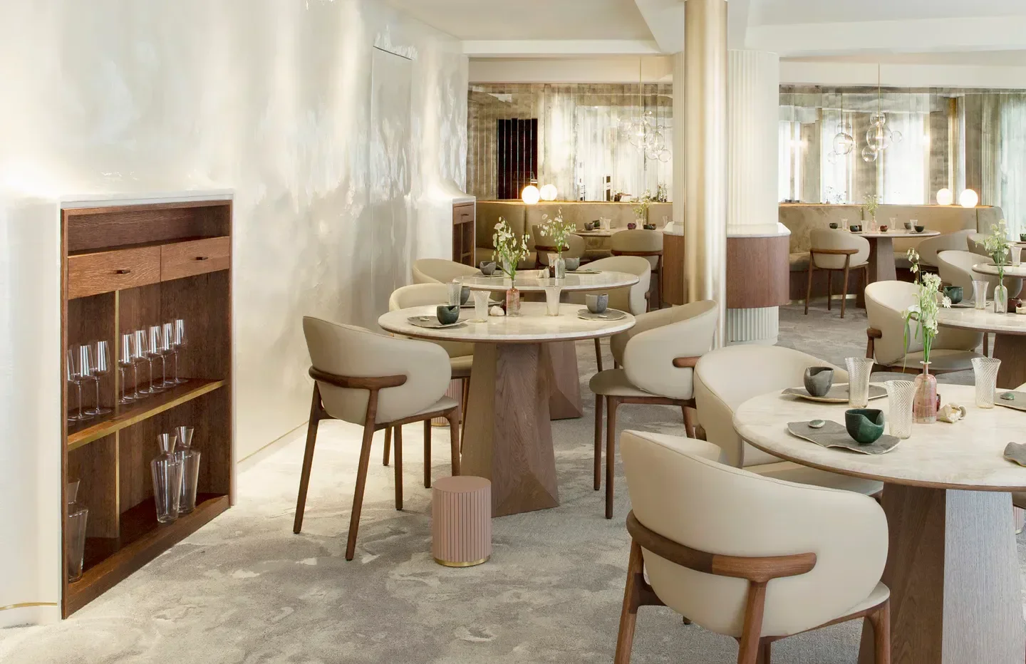 Elegant dining room interior at Marsan par Hélène Darroze in Paris, featuring stylish tables and chairs.