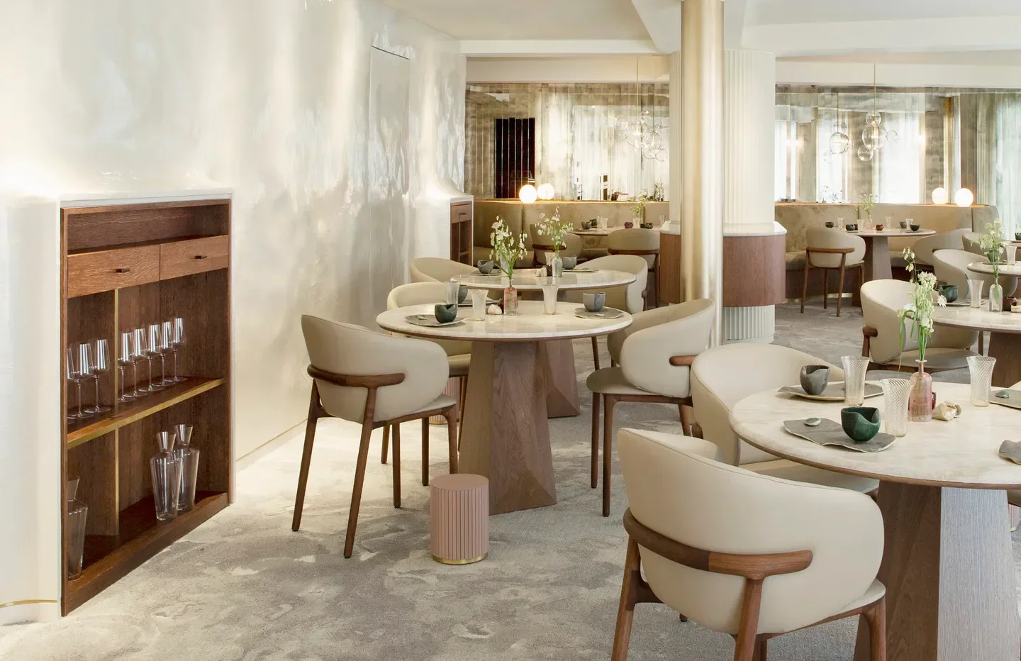 Elegant dining room interior at Marsan par Hélène Darroze in Paris, featuring stylish tables and chairs.