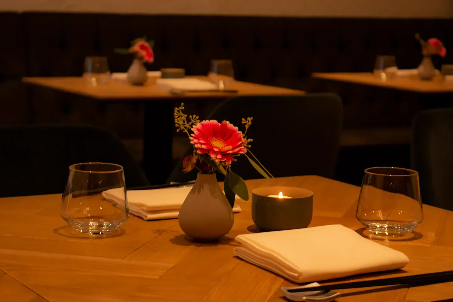Cozy ambiance at Masa Japanese Cuisine in Frankfurt, with candle and flower decor.