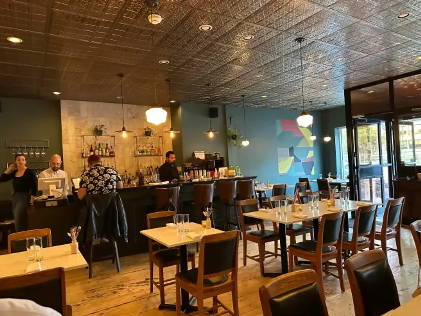 Interior of Mastard restaurant in Montreal, featuring bar and dining area.