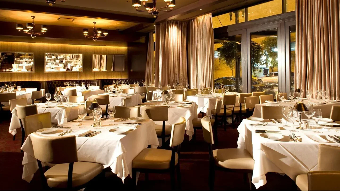 Elegant dining room at Mastro's Steakhouse - Chicago, with tables set for service in Chicago.