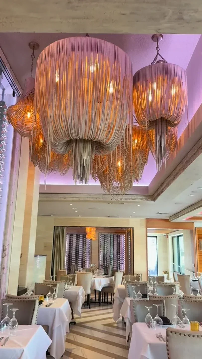Elegant dining area at Mastro's Steakhouse in San Francisco with unique chandeliers.