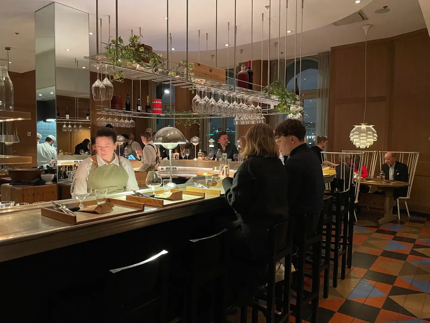 Stylish interior of Mathias Dahlgren – Matbaren restaurant in Stockholm, with guests at the bar.