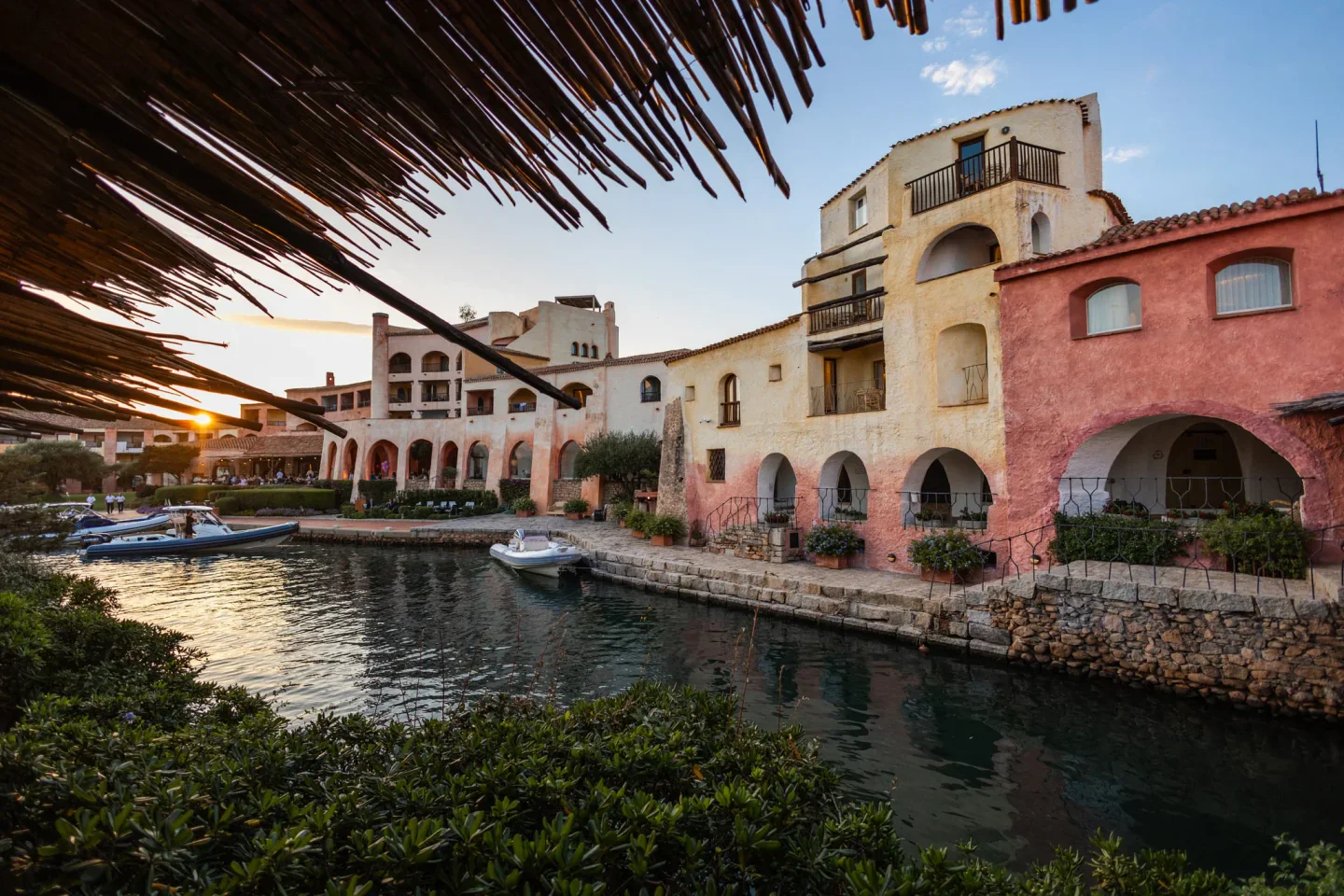 Waterfront view of Matsuhisa at Cala di Volpe restaurant in Porto Cervo with boats and sunset sky