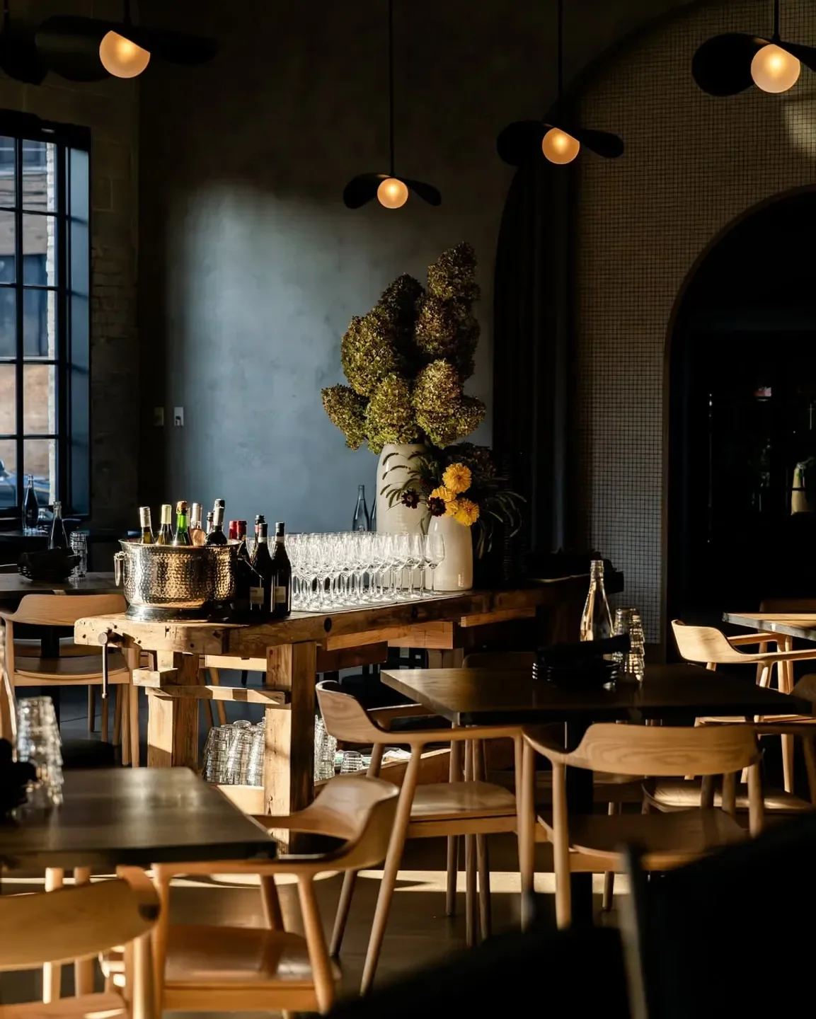 Interior of Maxwells Trading restaurant in Chicago, with elegant wooden tables and bar.