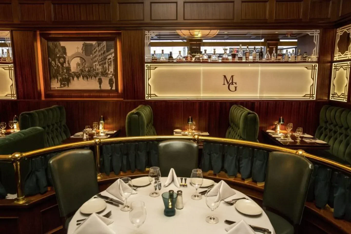 Cozy dining area at Metropolitan Grill in Seattle, with a vintage photograph and elegant setting.