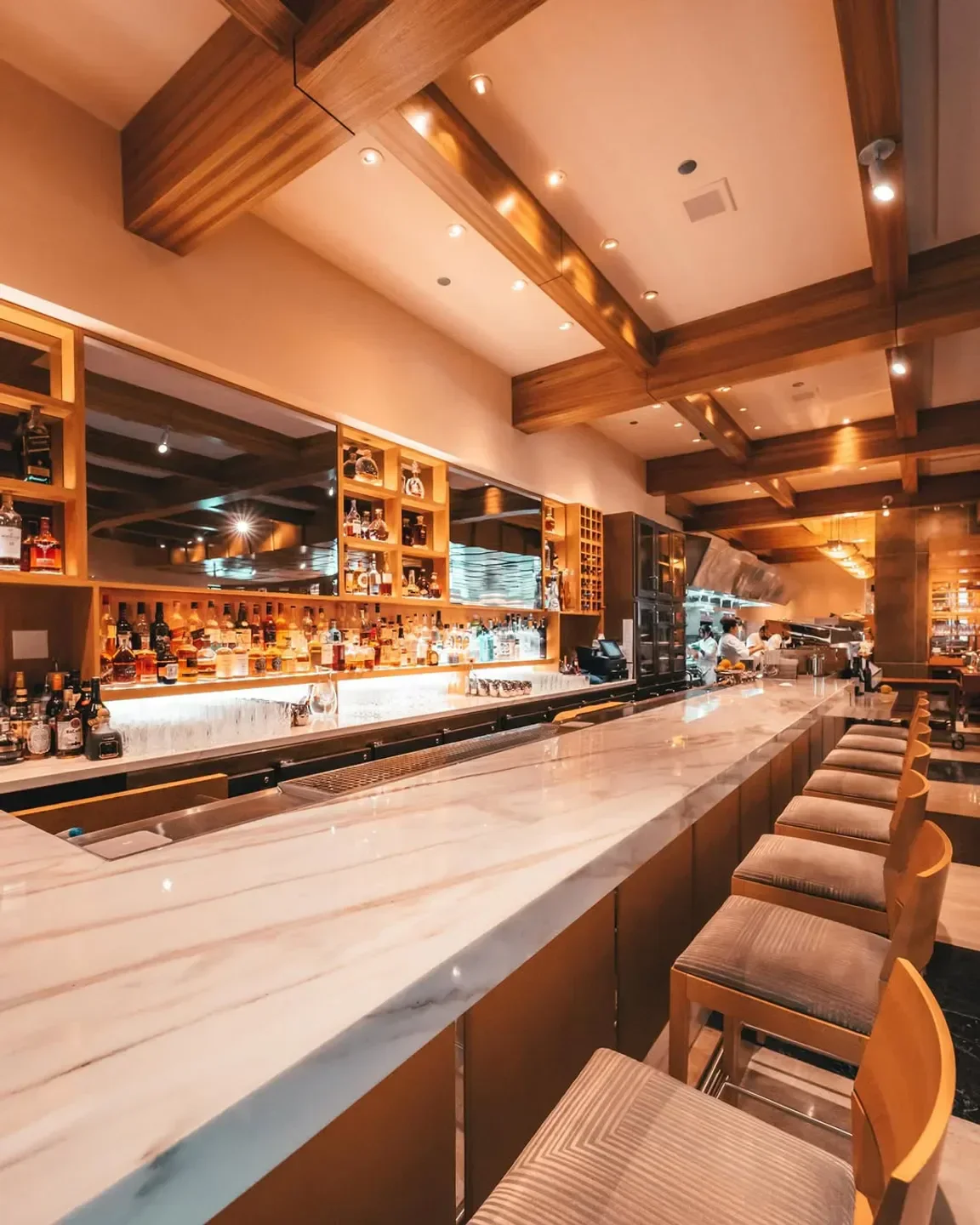 Interior of Michael Mina in Las Vegas with marble bar and wooden accents.