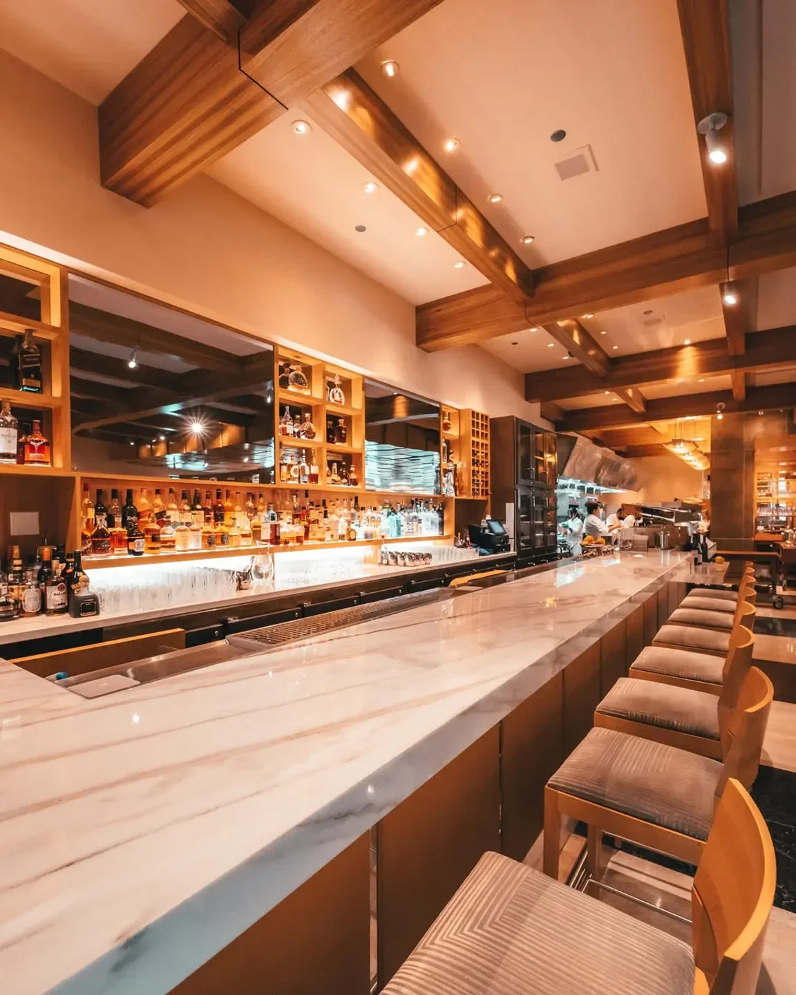 Interior of Michael Mina in Las Vegas with marble bar and wooden accents.