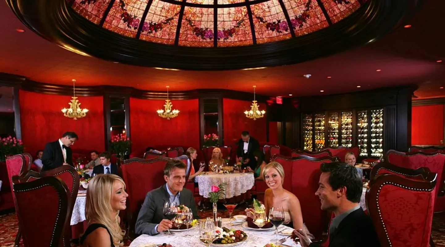 Elegant dining room at Michael’s Gourmet Room in Las Vegas, featuring stained glass ceiling