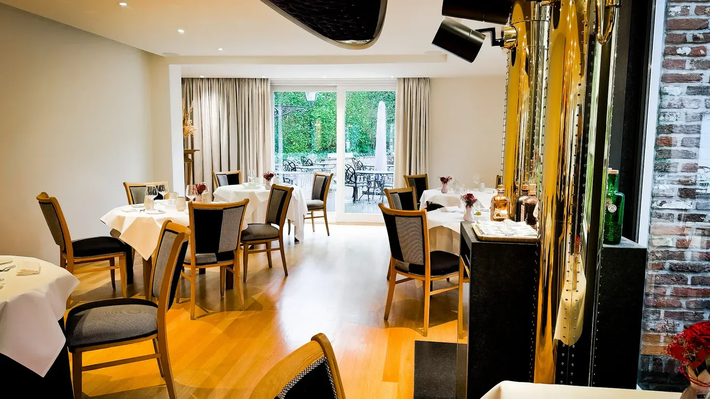 Elegant dining room interior at Michel restaurant in Brussels, with outdoor access.