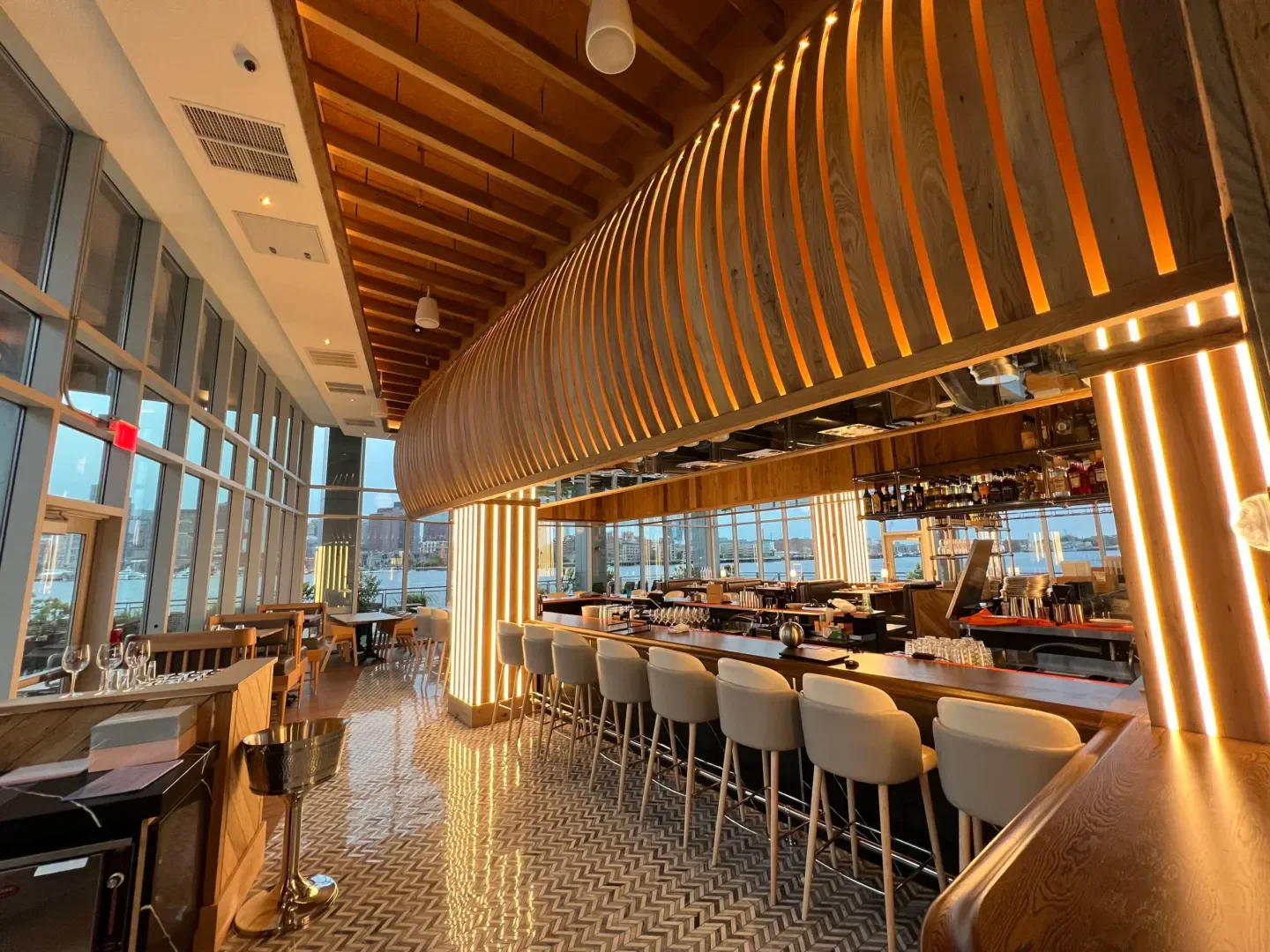 Interior of MIDA restaurant in Boston, featuring bar and stylish wooden decor.