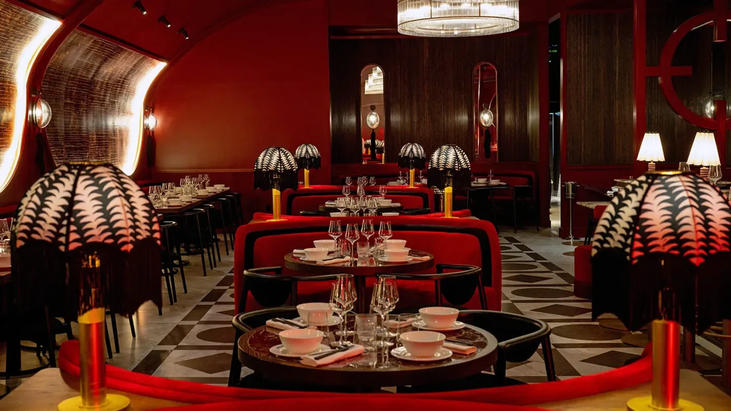 Elegant interior of MIMI Chinese in Toronto, featuring stylish lamps and red decor.