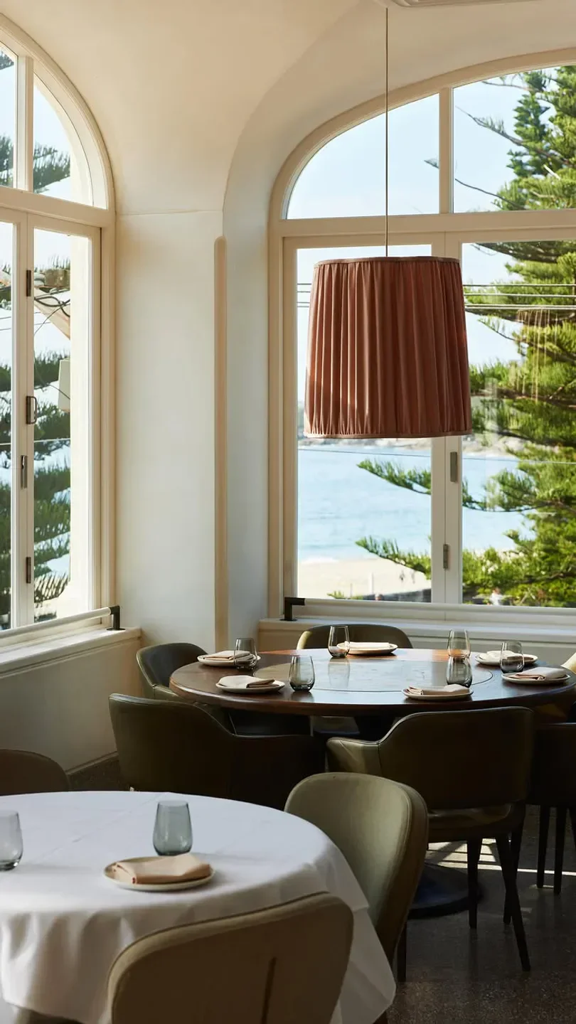 Elegant dining room at Mimi's in Sydney, overlooking the ocean with a stylish lampshade