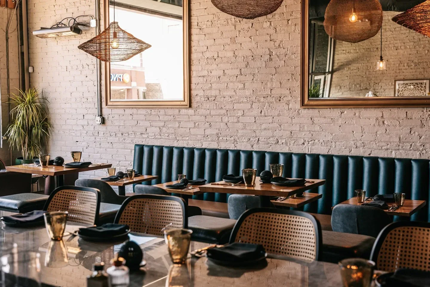 Interior of MIRRA restaurant in Chicago with stylish decor and unique lighting.